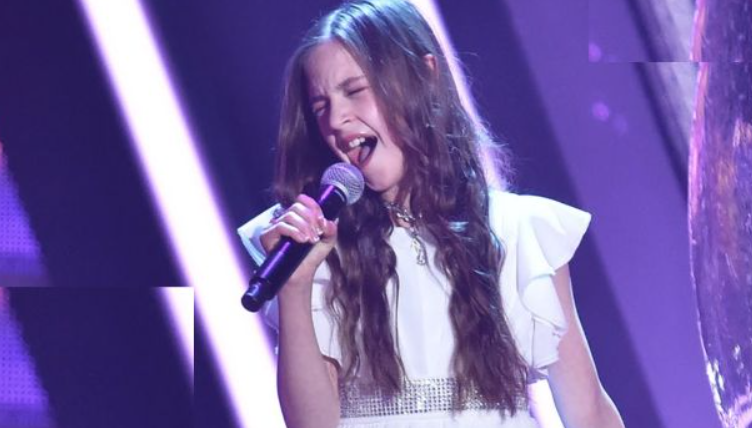 11-year-old enters the stage and announces that she will sing Elvis’ Can’t Help Falling in Love