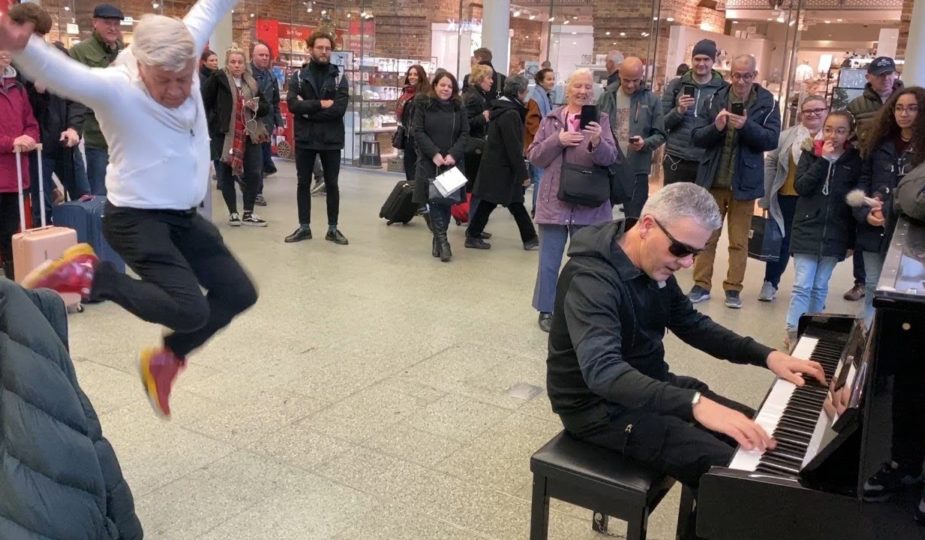 A 76-year-old man participates in a piano battle at the mall